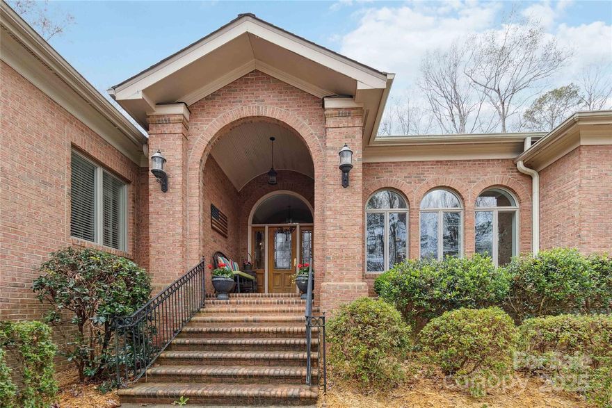 Welcome to this stunning custom home featuring a grand domed foyer and elegant columned dining room. The luxury kitchen boasts stainless steel appliances, multi use island, large breakfast and opens seamlessly to a sunken living room with a soaring stone fireplace, perfect for entertaining. The king-size primary ensuite offers a spacious bath and a walk-in custom closet. Each of the 3 additional bedrooms includes its own private bath. A cozy family room includes a builtin bar with icemaker, mini fridge, and glass cabinetry. Upstairs, you’ll find a bonus/playroom. This home also features a large laundry room. Enjoy an abundance of closet space and 3 oversized garages. The beautifully fenced backyard includes a paver patio and a gas firepit. Take the steps or the scenic path down to the fully stocked private pond, your own peaceful retreat. A circular drive and tons of extra parking complete this exceptional property. This home is a rare blend of luxury, functionality, and outdoor charm