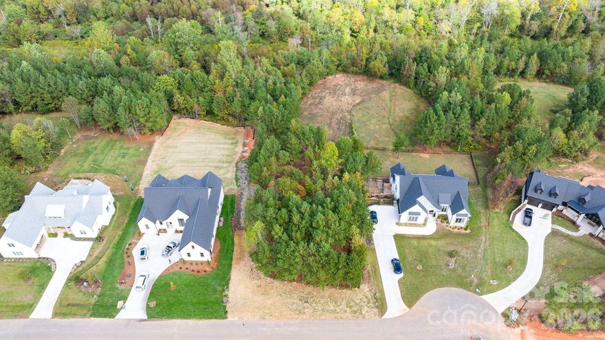 133 Addison Emory Lane, Lot 18 in Davidson Pond, is a 3.566-acre estate lot located 2.2 miles from Downtown Davidson, 7 miles from Mooresville, 4 miles from Langtree, and 4 miles from Freedom Boat Club on Lake Norman. The lot has been recently cleared for walkability and site visibility. Its natural slope is suitable for a walk-out basement and pool. The property has percd for 4 bedrooms, with off site septic field. A previous 60x70 house box with pool was permitted but since expired. Approved builders include Lakemist Homes, Artisan Custom Homes, and AR Homes. This will be the last home built in the cul-de-sac, and the mid-lot area allows space for a sport or pickleball court. Tour this lot with Aaron from Lakemist Home by contacting listing agent.