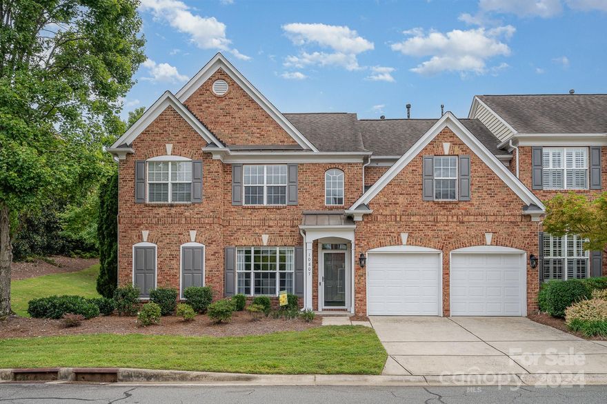 This stunning full brick end-unit townhome, just minutes from Ballantyne Village and I-485, offers both luxury and convenience. The main level boasts a primary suite, hardwood floors, and a spacious 2-story great room with a cozy fireplace. The gourmet kitchen impresses with high-end finishes, stainless steel appliances, a new full-size beverage fridge (2023), a large island with seating, and beautiful quartz countertops. Updates include two HVAC units, two furnaces, and new carpet (2020). Both the garage and outdoor patio feature durable epoxy flooring. Designer touches and abundant natural light enhance both levels. The backyard, with a new fence installed in 2023, is perfect for relaxing or entertaining. You’ll love the privacy and quiet location within the neighborhood. Zoned for top-rated schools! This townhome is a must-see!