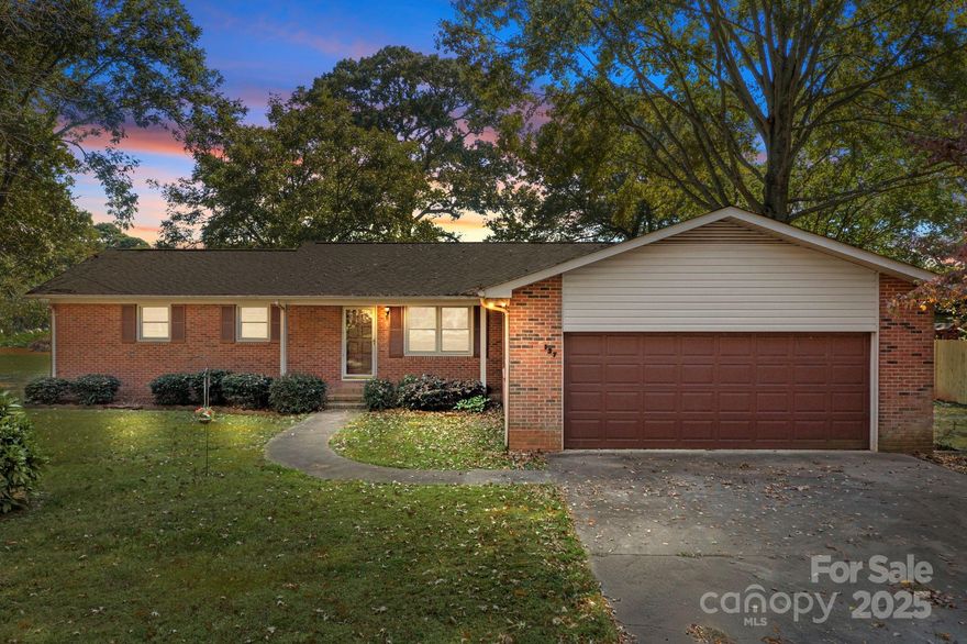 Charming full brick ranch-style home with a large back deck. This home features 4 bedrooms and 2 bathrooms, including a spacious primary bedroom. The dining room/den, complete with a cozy fireplace, sits just off the kitchen. The living room offers views of the front yard and covered porch. Situated on a level lot with mature trees and a spacious detached building in the back. This home also has laundry conveniently located off the kitchen. Perfectly positioned between the Langtree and the Williamson Road exit, it’s close to the interstate, restaurants, and shopping, with no HOA. Located on a small, quiet dead-end street with only a few homes. The interior has been freshly painted, and a new roof was installed in May 2025. Septic permit details are unavailable, so the bedroom count on the permit is uncertain.