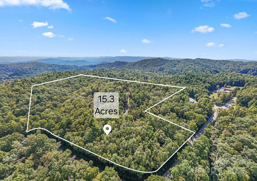 Discover the unmatched potential of this UNRESTRICTED 15.35-acre property located along Hwy 64 in the highly sought-after Lake Toxaway area within 10 minutes to Brevard. With stunning long-range mountain views that stretch for miles, this exceptional tract is ideal for residential development, a private family compound, or commercial use. The property is development-ready with three graded home sites, each equipped with well water, power boxes, and valid 3-bedroom septic permits on file with the county. Paved 18-foot-wide roads already in place meet state subdivision standards, streamlining your path to construction. Well produces 11 gallons a minute ideal for at least 6 houses. Whether you're looking to build custom mountain homes, create a private retreat, or launch a subdivision project, this unique opportunity offers the infrastructure, views, and location to make your vision a reality. Don’t miss this chance to own a prime piece of mountain paradise – your dream development starts here! Duplicate listing MLS#4304544