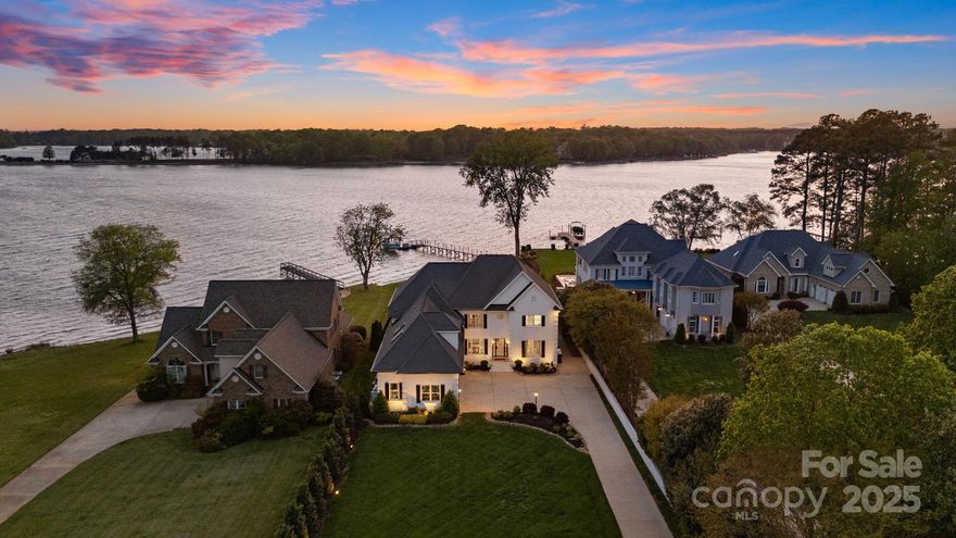 With endless, panoramic views stretching across open water, this exceptional lakefront home redefines waterfront living. Thoughtfully redesigned with a modern aesthetic, the home welcomes you with light-filled interiors, soaring ceilings, and floor-to-ceiling windows that frame the lake from nearly every angle. The gourmet kitchen is a true centerpiece, seamlessly blending high-performance design with sophisticated style—featuring a waterfall-edge quartz island, professional-grade appliances, and custom cabinetry. The serene primary suite offers a spa-like retreat with a soaking tub, frameless glass shower, and tranquil lake views. Upstairs, a second suite, additional bedrooms, a versatile bonus/media room, and a private office provide space for both relaxation and productivity. Outside, silver travertine terraces, a saltwater pool and spa, and a built-in Lynx grill create a resort-style setting—perfectly positioned to soak in miles of uninterrupted lakefront beauty.