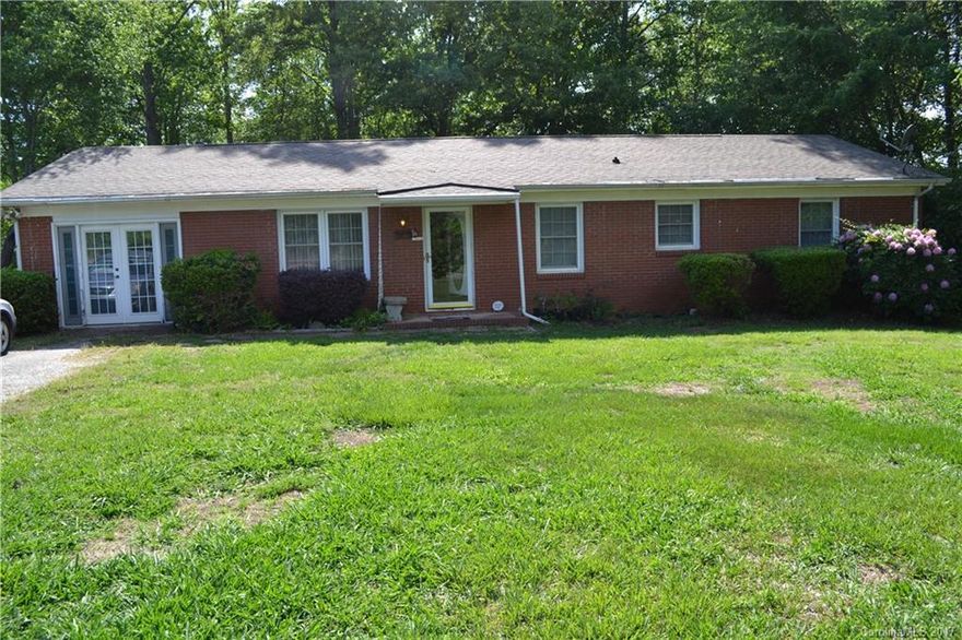Full brick ranch.  Beautiful hardwood floors, Open floor plan, large covered deck in the back overlooks private wooded fenced lot.  There is a free standing 1 car garage behind the house.   Home is being sold "as is" and is in need of repairs and updating.  City Water and sewer available.  Great investment/income property opportunity.