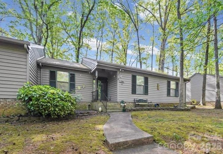 Tucked into a beautiful, wooded setting in the desirable Dogwood Hills community, this end-unit condo offers both privacy and low-maintenance living. Enjoy relaxing or entertaining on the spacious back deck, surrounded by mature trees. The single-level layout features three bedrooms and two bathrooms, with a functional floor plan and comfortable living spaces. A cozy wood-burning fireplace adds warmth and charm to the main living area. Whether you're a first-time buyer, downsizing, or looking for an easy lifestyle, this home offers a great balance of comfort and convenience. Located close to shopping, dining, and major commuter routes, everything you need is within easy reach. This property is also located in a USDA eligible area, offering the potential for 100% financing for qualified buyers. Please contact your lender for more details on eligibility. Schedule your showing today!