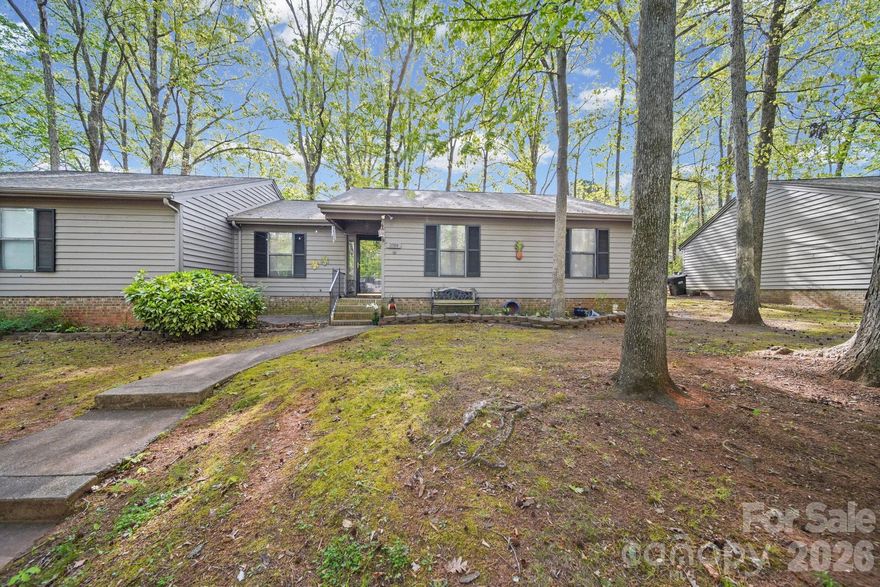 Tucked into a beautiful, wooded setting in the desirable Dogwood Hills community, this end-unit condo offers both privacy and low-maintenance living. Enjoy relaxing or entertaining on the spacious back deck, surrounded by mature trees. The single-level layout features three bedrooms and two bathrooms, with a functional floor plan and comfortable living spaces. A cozy wood-burning fireplace adds warmth and charm to the main living area. Whether you're a first-time buyer, downsizing, or looking for an easy lifestyle, this home offers a great balance of comfort and convenience. Located close to shopping, dining, and major commuter routes, everything you need is within easy reach. This property is also located in a USDA eligible area, offering the potential for 100% financing for qualified buyers. Please contact your lender for more details on eligibility. Schedule your showing today!