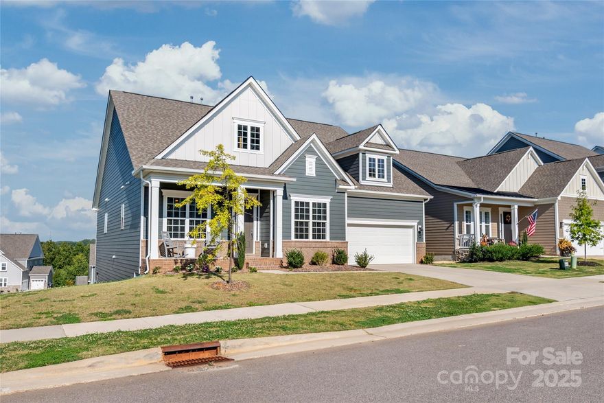 Outstanding home in Mooresville's Reid's Cove neighborhood, with sunset views of Lake Norman! Excellent, open floor plan with 5 bedrooms & 5.5 baths. Very well-maintained home and shows like a model. Features amazing kitchen with a spacious island, upgraded soft-close cabinets with lots of drawers, gas cooktop, stainless hood, and an elegant tile back splash. Three bedrooms on the main floor, including the primary suite! You'll have tons of room, with over 4,700 heated square feet, including the finished basement. (Basement has rough plumbing for wet bar or kitchenette.) Excellent set up for multi-generational living. 2023 construction. Enjoy beautiful sunset views from the triple-decker porch out back! Tesla Level 2 Car charger available in garage. Dual Rinnai tankless hot water heater, home theater pre-wire in basement. 3-zone HVAC. Gigabit internet / ethernet. Reid’s Cove amenities include a resort-style pool, lit pickleball court, playground, Lake Norman access & kayak racks. Take a paddle on Lake Norman and visit local restaurants for lunch or dinner. Excellent schools. Location offers easy access to shopping, restaurants, and entertainment in Mooresville and Davidson.