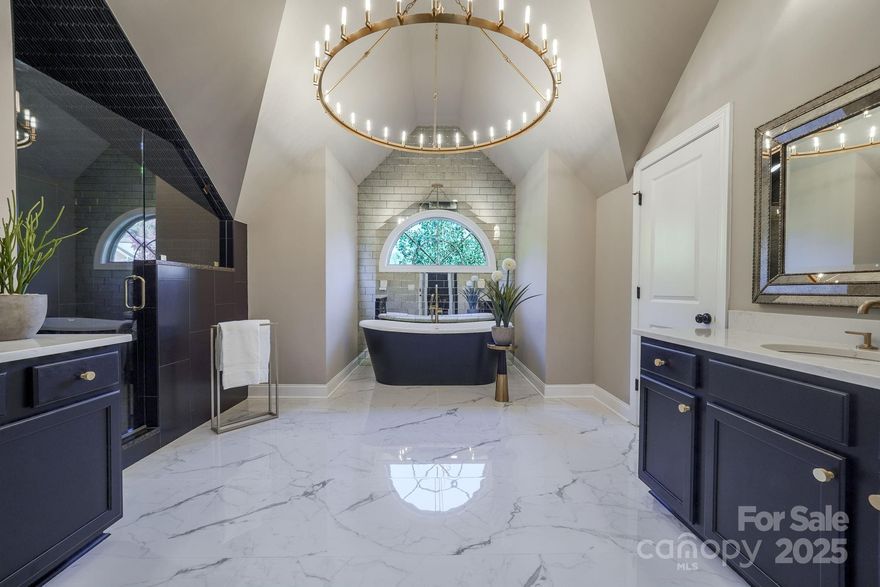 SOPHISTICATED ELEGANCE MEETS INVITING WARMTH ...Step into this PROFESSIONALLY decorated 5-bedroom, 4-bathroom home. The main level features a GUEST BEDROOM and FULL BATHROOM an office, and beautiful formal dining room boasting high-end lighting fixtures. The grand kitchen impresses with an OVERSIZED ISLAND, gas cooktop, wine bar, built-in ovens, quartz countertops and a seamless flow to the sophisticated GREAT-ROOM and SITTING AREA. Step outside from the sitting area to the SCREENED-IN PORCH and have a glass of wine while enjoying the sounds of nature.  Upstairs, the PRIMARY SUITE is a showpiece, offering a remodeled SPA-LIKE bathroom with freestanding tub, HEATED FLOORS, and luxury BRIZO fixtures. Dual custom closets with California closet systems (throughout home), art lighting a dressing area adds sophistication.  The second floor also includes a bonus room, laundry room, and 3 additional bedrooms and 2 full baths.  The third floor is already framed and plumbed for 2 more bedrooms, a full bath, and a bonus room-ready to be finished.  No lack of parking in the garages that offer 3 car spaces, epoxy flooring, custom cabinets, an organizing wall, and workspace.  The outdoor space is equally stunning, featuring a LARGE FENCED YARD, landscape lighting, an OUTDOOR KITCHEN with a gas line for the built in grill and stone fireplace sitting on a spacious patio-all overlooking a peaceful WOODED BACKDROP. This home perfectly blends luxury with comfort-like a page from Architectural Digest. Exceptional resort-style community amenities-pool, clubhouse, trails, tennis and pickleball courts sidewalks that lead to a variety of businesses including a butcher shop, bakery, coffee bar, dentist, drycleaners, vet office, salon, and fitness center.  Bridgemill is minutes from restaurants, Costco, Target and much more! Photos will be uploaded 10/24/2025