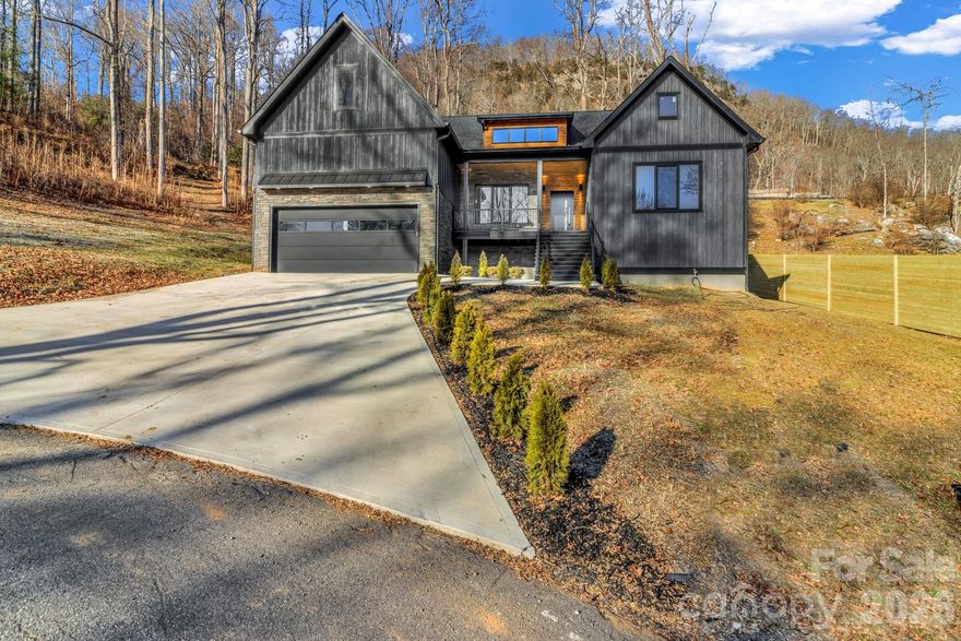 Discover this stunning 2,750 sq ft new construction home just 10 minutes from downtown Asheville. This thoughtfully designed home offers 3 bedrooms and 2.5 bathrooms and a laundry room on the main level, with a bonus room and full bath upstairs—perfect for guests or a private suite. Gorgeous real hardwood floors throughout, 10-foot ceilings, and real tile in every bathroom. The spacious kitchen features a large island, quartz countertops, gas stove, and a cozy gas fireplace in the living area. The main level also includes a dedicated office, ideal for remote work or creative space. An additional 1,000 sq ft of unfinished attic space offers future potential. Step outside to a peaceful backyard with a recently installed wooden fence for added privacy as you sit around the fire pit and enjoy the close-range mountain views.  A perfect blend of modern finishes and natural beauty, this home offers the best of Western North Carolina living. Don’t miss the opportunity to own a quality-built home in a prime location.