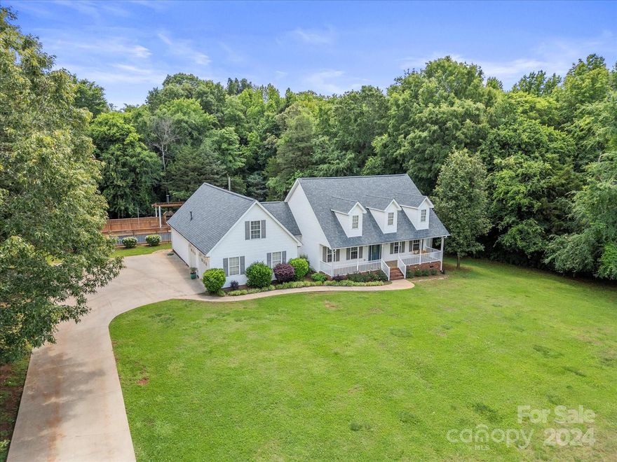 Welcome to 2391 Blossom Dr, a stunning 4-bedroom, 3- full bathroom home on a serene 1.42-acre lot in Rock Hill, SC. This 3,316 sq. ft. property features all primary living areas on the main floor, plus two large bonus rooms upstairs ideal for a home office, gym, or playroom. Enjoy the amazing in-ground pool and covered deck, perfect for outdoor entertaining. The backyard is wooded for exceptional privacy, while the level front yard offers a welcoming entrance. Additional highlights include a spacious two-car garage with additional storage and a large driveway, ideal for extra parking or basketball games. Relax on the covered front porch or covered back porch that overlooks the pool. Don’t miss the chance to own this incredible home with ample space inside and out. Schedule a showing today!