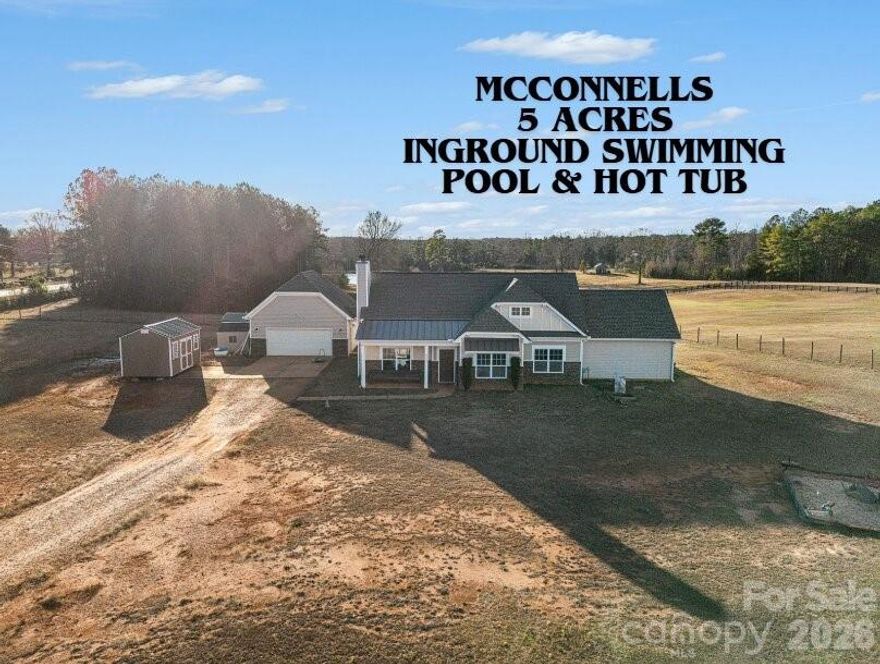 Welcome to McConnells, just outside of York, Rock Hill, and all that Charlotte has to offer! This wonderful home sits on 5 acres and is fully fenced in, perfect for the little farm you always wanted! The property features a mostly level lot, a two car detached garage with breezeway, outbuildings, a pond view, a rear covered porch, a 3-6 foot deep heated inground swimming pool with surrounding cement patio, a built in hot tub next to the pool, a firepit, mature trees, and the most beautiful evening sunsets! Inside you will find a three bedroom home that functions as a four bedroom all on one level. The inside features tons of natural light, vaulted ceilings, a stone facing fireplace, engineered hardwood flooring, eat in kitchen with island seating, granite countertops, stainless steel appliances, easy walkout to the back covered porch, hallway laundry, three spacious bedrooms and closets, and a large bonus room/closet that functions as a fourth bedroom. This is country living at its finest!