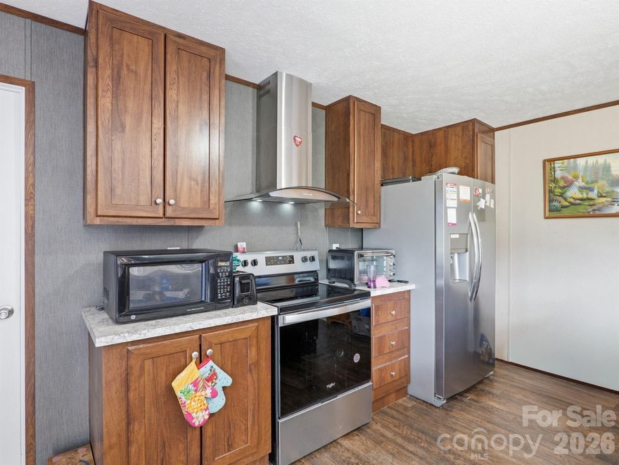 Situated on a spacious 1.27-acre corner lot, this home offers an open, level setting with plenty of room for entertaining. A wired, oversized detached garage provides the perfect space for a workshop or extra storage. Inside, the open floor plan connects the living room, dining area, and kitchen, creating a welcoming and functional layout. The kitchen features ample cabinetry and a large island with a breakfast bar, while the split-bedroom floor plan offers added privacy and comfort. Plenty of parking in the driveway. Enjoy the Quiet Country life!