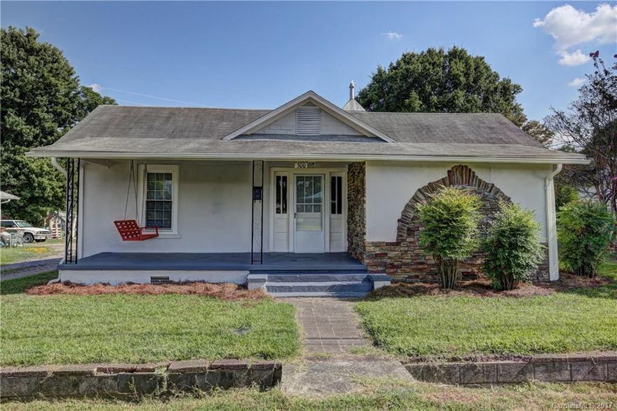 PRICE REDUCTION! Charming renovated bungalow within walking/bike distance to Research Campus! Three bedrooms (2 with armoires, not built-in closets). Two full baths; master bath has dual seat tiled shower; wonderful beadboard in 2nd bath! Freshly painted interior & exterior; professionally cleaned & ready for move in! Back deck newly treated. New door to exterior basement/root cellar entrance. Rocking chair front porch features swing. Persimmon trees & crape myrtle trees grace this corner lot!