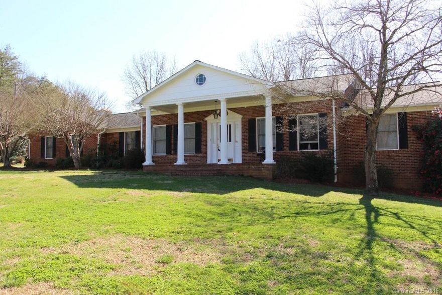 Colonial style home w/ basement on over 3 acres has 3 BRs, 3 BAs with oversized rooms & extra space. A covered, front porch w/ tall, white columns & large foyer welcomes you. A spacious living room features a brick, wood burning, 2 sided fireplace & built-in shelving. Opposite the living room is a den w/ 2 sided fireplace that flows into the formal dining room featuring crown molding & chair rail. The kitchen has built-in cabinets, SS appliances & is adjacent to a large laundry room/pantry.