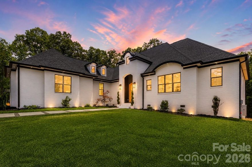 Timeless European design meets elevated modern living in this beautifully crafted one-story, ranch home. From the striking white-painted brick exterior to the arched entry and warm wood-stained front door, every detail creates a refined first impression.

A clean-lined paver walkway with pebble inlay leads you inside to a light-filled, open-concept layout with soaring vaulted ceilings!

The kitchen is a true focal point, featuring an oversized island, custom white cabinetry, quartz countertops, a classic subway tile backsplash, and a custom range hood—all accented by designer lighting throughout.

The primary suite is a private retreat, featuring a free standing soaking tub wrapped in walls of marble-inspired tile and a luxurious oversized walk-in shower!

A flex space off the main living area offers tons of natural light and endless versatility—perfect for a private office, drop zone, art studio, homework space, playroom, future butler's pantry/bar area, or just a fabulous storage space for seasonal decor! 

Thoughtfully designed secondary bedrooms share a Jack-and-Jill layout, while the spacious laundry room adds both function and convenience with additional cabinetry and storage.

Located just minutes from Lake Wylie and approximately 30 minutes to Uptown Charlotte, within the highly sought-after Clover School District. Riddle Mill Road is quickly emerging as one of Clover’s most desirable luxury corridors—where refined homes meet a quiet, countryside feel just minutes from everyday conveniences.