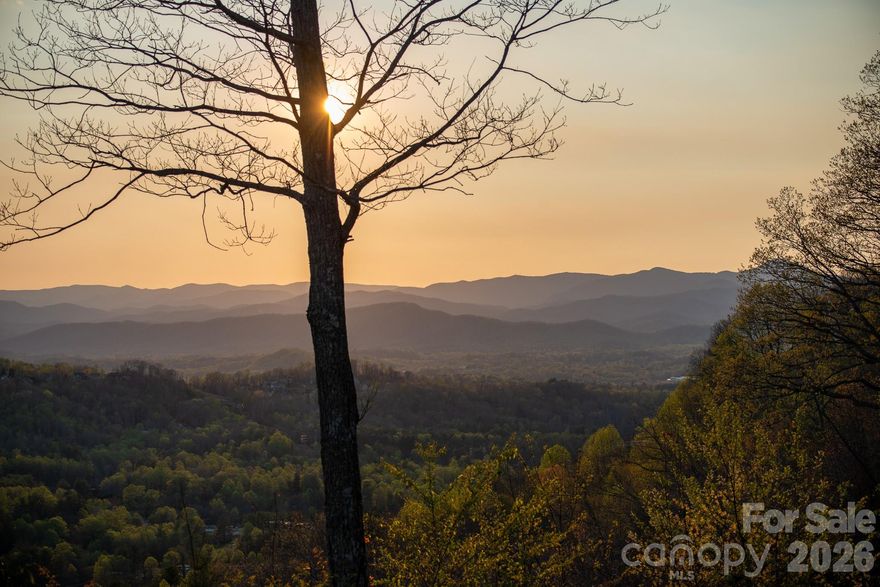 Some lots you look at and think, “nice.” This one stops you cold.

Sitting at the very top of The Boulders, this nearly 1.7-acre homesite has views that stretch east to west with layered ridgelines, open sky, and sunsets that honestly don’t feel real until you’re standing there watching them. It’s been called one of the most spectacular views in the region, and standing on the lot, you’ll understand why that’s not an exaggeration.

What makes it genuinely rare isn’t just the views, it’s that the land cooperates. Flat, gentle topography with two possible building sites, both with those views wide open in front of you. In the mountains, that combination almost never happens. You can plan your dream home plus an ADU or guest house, outdoor living, a fenced yard — all of it fits!

Everything’s already done: paved driveway, AT&T fiber, natural gas, city water, power, and a pervious 4-bedroom septic permit. No required build time. Bring your own builder and plan, or choose from a semi-custom collection.
The Boulders is a gated mountain conservation community and the location is the kind you don’t expect to find this far up a mountain. 10 minutes to Main Street Hendersonville. Under 25 minutes to downtown Asheville and the Blue Ridge Parkway. It’s private and peaceful up top, but you’re never far from anything.

Just reduced by $100,000 — and if you've been looking for the one, this is probably it.