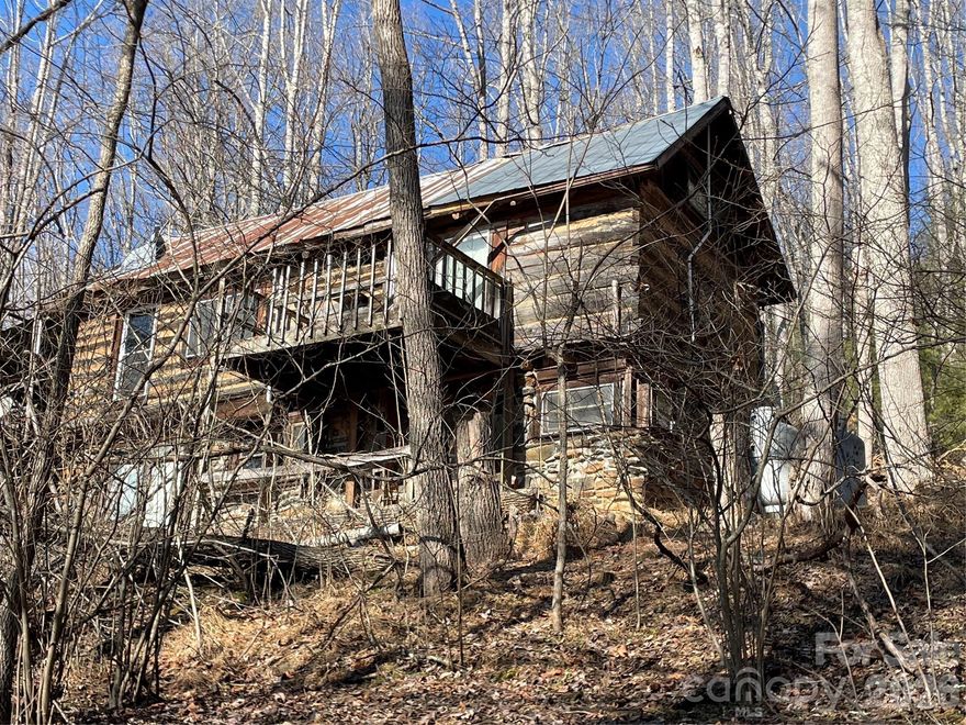 Close to Penland School! Rare opportunity. These two parcels include two structures, the cabin and approx. one acre at the bottom does not convey. The cabin at the top has a rich history of ownership, but needs attention to bring it back to life. Original wood logs and woodwork. Unable to verify the septic systems and water sources.