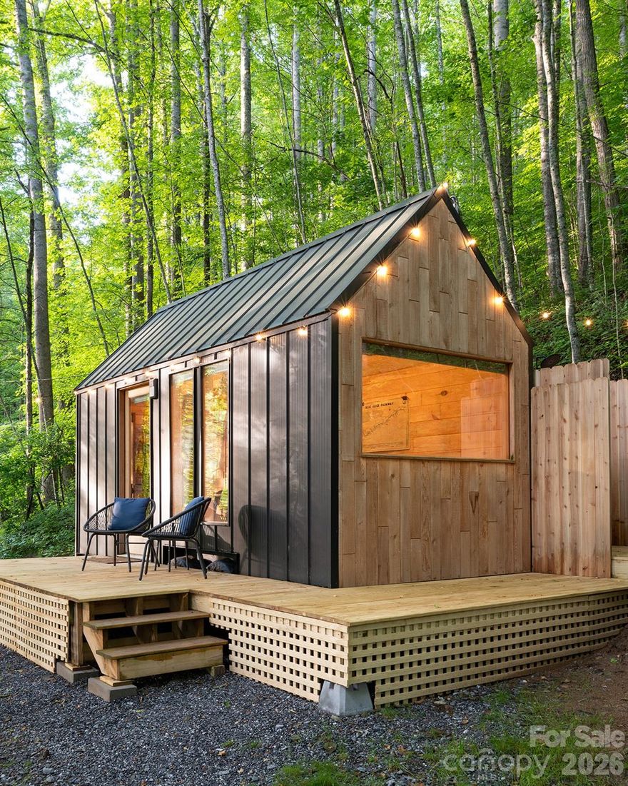 Whisper Woods is a turnkey micro-resort between Waynesville and Sylva, North Carolina, offering five uniquely themed, upcycled park RV cottages that function as a cohesive, high-performing short-term rental community. Each unit showcases unique outdoor amenities and private seating areas, with select homes featuring hot tubs, saunas, and private fire pits—designed to create intimate, resort-style experiences in a tranquil forest setting.

Cottage highlights:
Fern: Romantic retreat with a king bed, private hot tub, deck, and outdoor fireplace.
Locust: Relaxation-focused with a barrel sauna, large deck, and an indoor electric fireplace.
Twig: Nordic-inspired design with an outdoor shower and a bathtub surrounded by nature.
Evergreen: Built in 2024, a “deck in the trees” with a king bed and windows that invite stargazing.
Portkey: A one-of-a-kind Harry Potter–themed cottage handcrafted from a recycled horse trailer.

Investment and management:
Turnkey operations with an established management plan and a history of strong occupancy and solid gross revenue.
Attractive upside potential in a post-Helene market; comprehensive financials, occupancy trends, and expense data are available to qualified buyers through the managing office.
Proven branding and guest appeal across five distinct experiences, encouraging repeat bookings and word-of-mouth referrals.

Location and access:
Centrally located between Waynesville and Sylva, NC.
Proximity to outdoor attractions:
 ~8 minutes to the Blue Ridge Parkway
 ~35 minutes to Great Smoky Mountains National Park
 ~45 minutes to Asheville