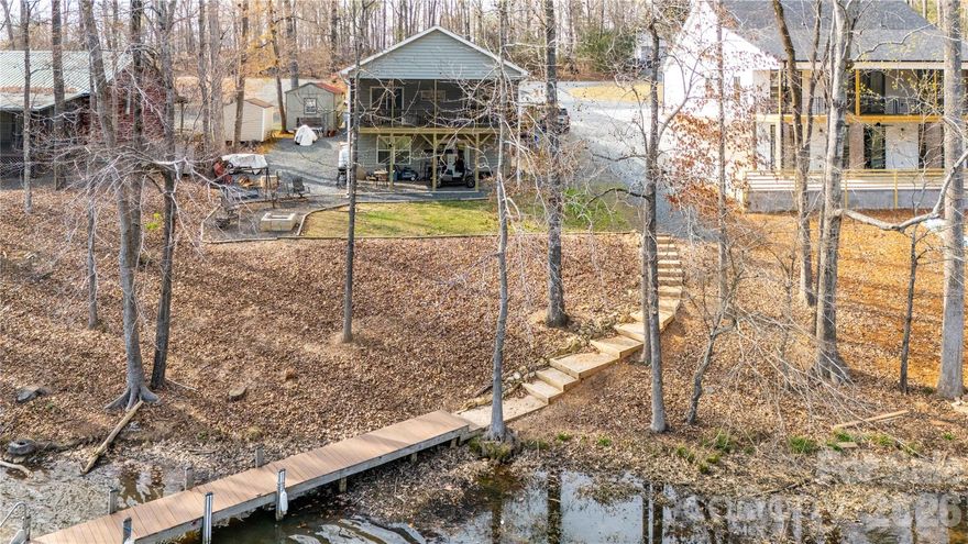 Immaculate 3 bedroom / 2 bath waterfront home in Woodrun on Lake Tillery !!! Open floorplan with a fireplace and gas logs in the living room. There is a 335 s/f screened porch on the lake side. The gently sloped / cove lot takes you to the waterfront with approximately 76 feet of shoreline and a pier for docking your boat. The basement workshop has 324 s/f and could be finished should you need the additional living area. There is also a storage building that conveys with the property. Woodrun is a gated community with amenities - clubhouse, community inground pool / sunbathing area, tennis, pickleball, basketball courts, walking trails and community boat launch. If someone would want to add a boathouse that would not be a problem, but agents should confirm this with Duke Energy in your due diligence period. Perfect for vacation, permanent residence or rental property. Come find your spot on Lake Tillery !!!