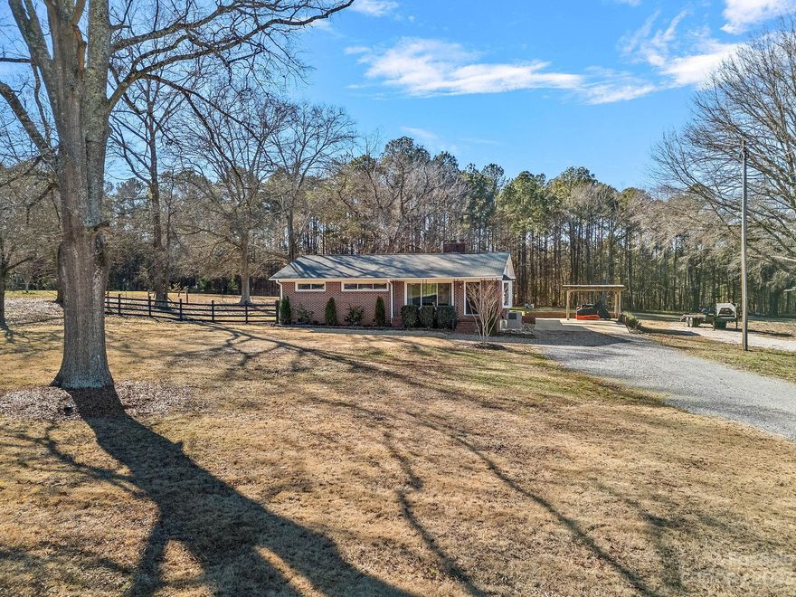 Look no further! This brick ranch home sits on 7+ acres and offers so much, perfect location - convenient to Rock Hill Country Club, schools, shopping and I-77 / 30 minutes from Charlotte. Back portion of lot has been professionally cleared and graded with professionally built pad ready for your barn/shop. The newly added separate driveway is convenient for back pasture access, new 2023 HVAC system with all new duct work, new gutter systems in 2023, updated electric, updated plumbing, as well as newer vinyl windows. Nice shed/workshop behind home, perfect for storage or small projects. Fencing around perimeter except small area behind house/driveway portion. Taxed as farm use.