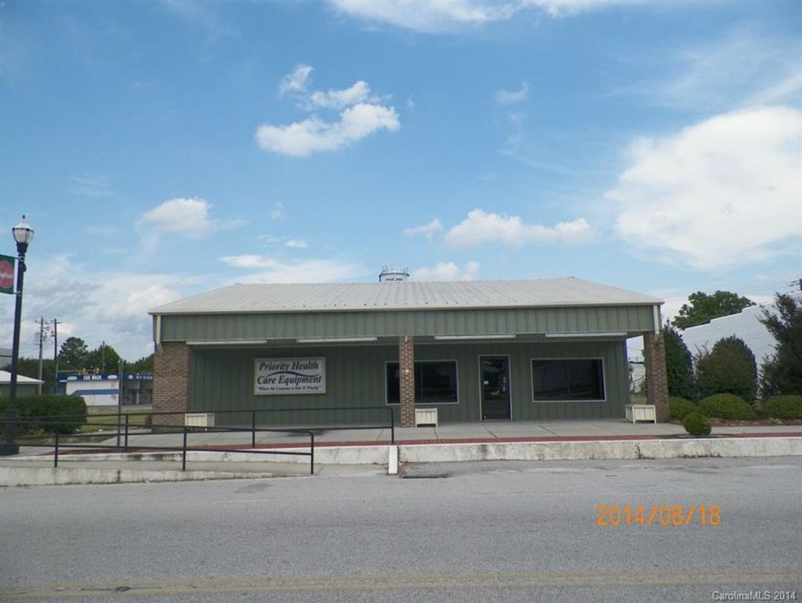 Office/warehouse located on large corner lot in Pageland, S.C.  The approx. 2,500 sq. ft. metal frame building has open lobby, reception work area, 4 offices, kitchenette, restroom and finished warehouse area.  The warehouse area consists of approx. 696 sq. ft. of the total square footage.  There is a stairway in the warehouse leading to an unfinished attic area.  Also included is a small metal frame building with approximately 160 sq. ft. with restroom.  Easy access to Pearl St and McGregor St.