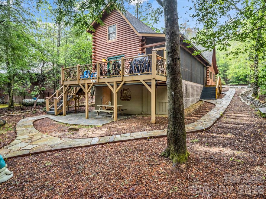 Tucked inside the gated mountain community of Connestee Falls, this updated log cabin delivers the authentic mountain feel buyers are searching for - without sacrificing modern comfort. From the moment you step inside, you’re greeted by soaring ceilings, warm wood tones, and a layout that simply works. The open-concept floor plan creates a natural gathering space, while the impressive loft lives like a true third bedroom - ideal for guests, kids, or even a tucked-away home office. It’s one of those designs that makes the home feel larger than you’d expect.
Thoughtful updates throughout provide peace of mind and style, including an upgraded HVAC system, tankless water heater, refreshed kitchen, updated lighting, and beautifully restored hardwood floors. Outside is where this property really sets itself apart. The level lot offers usable, grassy yard space - a rare find in the mountains - along with a private backyard and a gentle stream bordering the property. Whether it’s morning coffee on the porch or evenings around a fire pit, this setting invites you to slow down and stay awhile. All of this within minutes of Connestee Falls’ top-tier amenities: championship golf, lakes, pickleball and tennis courts, hiking trails, wellness center, dog park, and a vibrant clubhouse community. If you’ve been waiting for a true mountain cabin with character, functionality, and updates already in place - this is it.