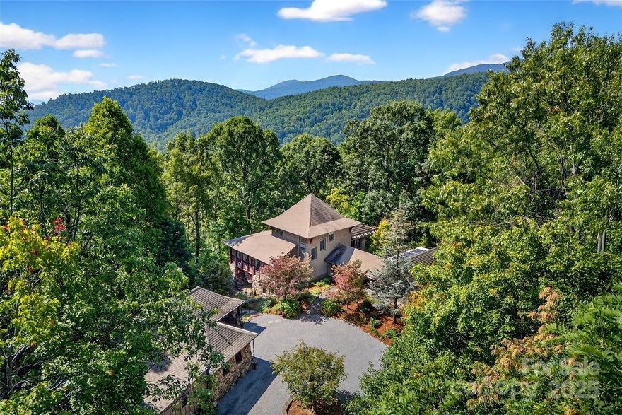Welcome to your own private mountain retreat, where every detail has been thoughtfully designed to blend comfort, quality and natural beauty. Nestled on a professionally landscaped, flat-access 15.8 acre lot within the gated Gateway Mountain community, this property offers the perfect balance of serenity and convenience. As you arrive, a tree-lined pebble driveway sets the tone, guiding you toward a home defined by architectural grace that truly embraces its surroundings. The living room's soaring floor-to-ceiling windows that frame sweeping mountain views, gives the feeling of living among the treetops. Natural light pours through the open spaces, enhancing the home's unique design and craftsmanship. Imagine sipping your morning coffee on the screened porch while listening to the soothing sounds of the garden fountain or your guests taking a peaceful stroll down the back pathway to the charming 1 bed, 1 bath guest cottage. After a day exploring downtown Old Fort, nearby Black Mountain or Asheville, gather around the firepit under the stars or enjoy a game of shuffleboard or darts in the lower-level rec room while mixing your favorite drinks at the wet bar. Call it a night and retreat to the primary ensuite with its beautiful vaulted ceiling, walk in closet, walk in shower & heated bathroom floors.  Guests have their options; a secondary ensuite with amazing views, downstairs bedroom, hallway twin bed hideaway (kid favorite) or the cozy guest cottage complete with microwave, coffee maker and mini fridge. The detached garage offers more than just parking- it features an oversized 1 car parking area with workbench & sink, a finished flex room with separate entrance, network ready and hidden storage closet plus expansive heated and cooled lower level workshop with toilet, utility sink, air compressor piping & parking space for your ATV or golf cart. This home was built for both beauty and efficiency, boasting a geothermal HVAC system, propane generator, solar energy system and a 750 gallon cistern. Every feature reflects a commitment to quality and thoughtful living.  Gateway Mountain itself offers endless opportunities to explore: hiking trails, waterfalls, lake, fishing pond, picnic area, Friday happy-hours and seasonal gatherings.
Whether you're seeking a weekend escape or a full-time residence, 789 McKenzie Way S is more than a home-its your slice of mountain paradise. Furniture & household items can be included with acceptable offer making it truly turnkey and ready for you to make lasting memories!
Additional Sq footage is garage workshop, third level sq ft is for finished flex/office space in detached garage and is reflected in total primary HLA but is not in main house (main house HLA is about 3,140 sq ft, garage sq ft is for upper level garage space. Please have your agent print out additional features of house/property located in attachments.