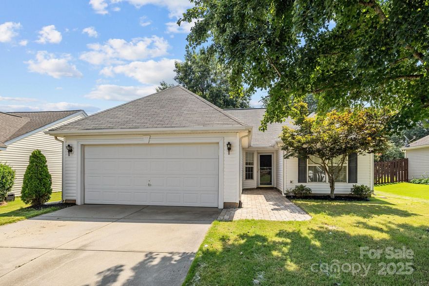 Adorable, Affordable, and Move-In Ready! This freshly painted 3-bedroom, 2-bath ranch-style home offers charm, comfort, and convenience. Enjoy a bright, open floor plan with neutral finishes throughout and no carpet. The spacious kitchen overlooks the living area—perfect for entertaining. Dramatic cathedral ceilings elevate the space giving the home an expansive feel. Step outside to a large paver patio, private, fenced backyard—ideal for pets, play, or future outdoor living additions. A 2-car garage provides plenty of storage and parking space. Located just minutes from the new Ballantyne Bowl and all the exciting new development along Route 521, including Redstone Shopping Center, Costco, Target, and more. Neighborhood amenities include pool, playground and sport court! Don’t miss this opportunity to own in Indian Land with low SC taxes and great schools.