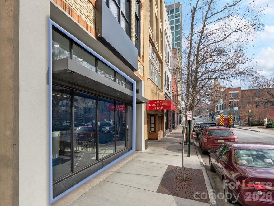 An office that makes a statement. This beautifully renovated ±2,400 SF, two-level suite at 39 Patton Avenue delivers a rare combination of modern design, functional efficiency, and prime Downtown Asheville visibility. 

Originally built in 1928 and renovated in 2023/2024, the space features a high-end Class A buildout with exceptional attention to detail. A 9-foot door opens into a light-filled interior with 14-foot ceilings, floor-to-ceiling windows, and contemporary lighting, creating an immediate sense of professionalism. Suspended acoustic ceiling panels enhance aesthetics and sound control, while warm LVT flooring and clean finishes provide a refined, cohesive look. Glass walls and partitions allow natural light to flow throughout the space while maintaining acoustic separation.

The layout supports a wide range of workplace styles, including executive offices, collaborative team areas, and client-facing meeting spaces. The lower level features a large conference room comfortably seating 10, a private office, open lounge and collaboration area, and a kitchen/dining space with custom backsplash. The upper level offers an open lounge and flexible meeting/work area, a private office and call room, restroom, and additional storage areas. 

Elevator and stair access serve both floors, providing excellent circulation and accessibility. A secondary entrance from College Street provides immediate access to the Rankin Avenue parking garages, further enhancing convenience.

Surrounded by the city’s highest concentration of offices, restaurants, retail, and professional services, the building benefits from exceptional walkability, earning a Walk Score of 94 (“Walker’s Paradise”). 

Easy access to I-240 and major routes ensures easy and efficient connectivity.

This move-in-ready office suite is ideal for professional firms, creative companies, and client-facing businesses seeking a polished downtown presence without the cost, time, or disruption of new construction. Few spaces in Downtown Asheville offer this level of design, functionality, visibility, and convenience in a single package.