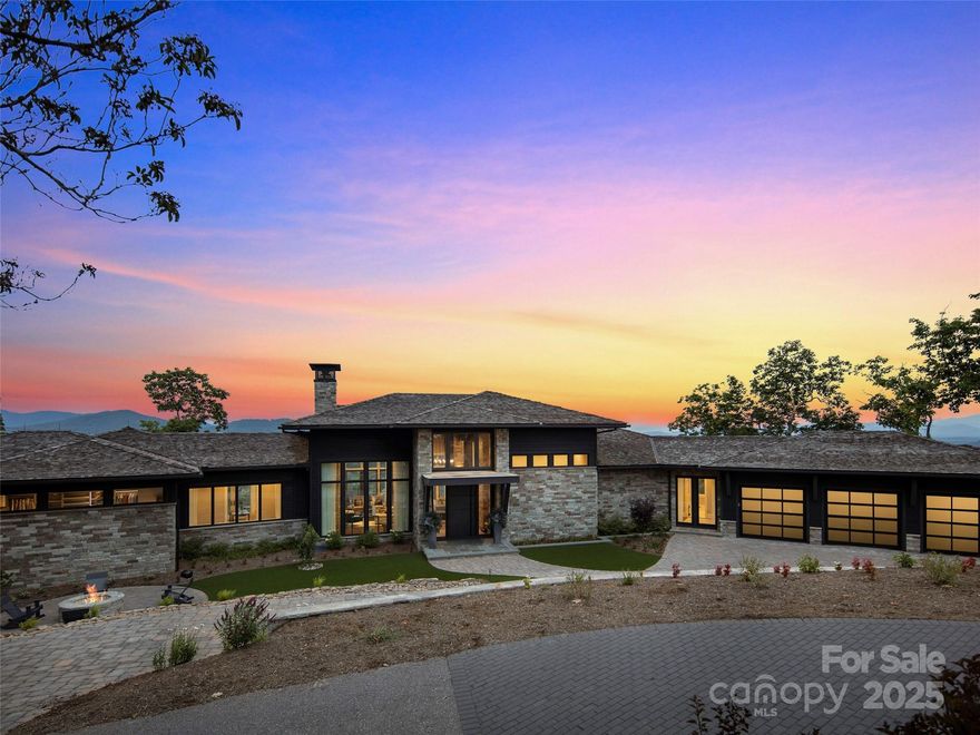 Poised above the pristine fairways of Walnut Cove and framed by panoramic year-round vistas including Asheville’s twinkling lights, this exquisite residence offers over 7400 SF of refined mountain living. Designed by Jeff Dishner, architect, Dillard-Jones construction and decor by Tribus Interiors, you’ll find two expansive living levels that capture the beauty of the surrounding valley with year-round vistas. The main-level layout is tailored for both relaxation and productivity, with two home offices and an owner's suite. This private retreat is complete with its own balcony, spa-like bath featuring a jetted soaking tub, heated floors, steam shower, separate water closet, and walk-in closet. The kitchen includes a hidden pantry, custom cabinetry, Sub-zero and Wolf appliances. The Cliffs at Walnut Cove membership is available.