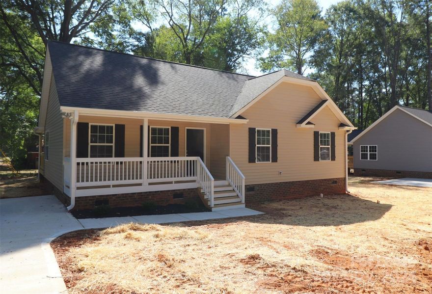 This delightful RANCH home is located close to historic downtown York, SC.  Bright and neutral. Luxury vinyl flooring in the main living areas which is pretty as well as practical. The eat-in kitchen offers dark espresso cabinets with granite counters, SS appliances, good storage & prep space, and a breakfast bar. The dining area opens to a large covered rear porch - perfect for indoor/outdoor entertaining. Vaulted Family Room. The Primary is accented by a tray ceiling with an ensuite full bath with granite counters. Two nice-sized secondary BRs & full guest bath. Long driveway can accommodate 3 vehicles. Nice level lot and a charming front porch.
