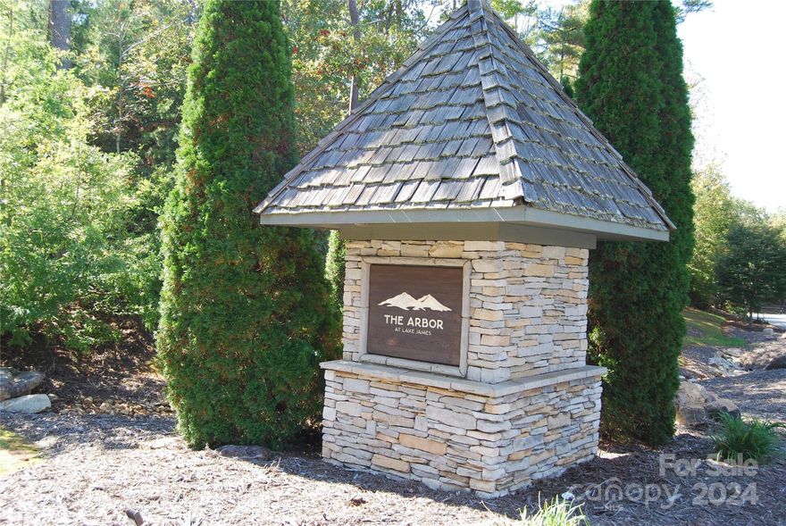 Enjoy one of Americas most popular fresh water mountain lakes in the beauty of North Carolina. Almost level lot near the back gate for easy access with it's own boat deeded boat slip a very short distance away, easily accessed with a golf cart or ATV. Easy build site to enjoy all Lake James has to offer in a private community. Boating, swimming, fishing, all just a few steps away!  Listed below tax value, a great value for a premium lot in The Arbor at Lake James.