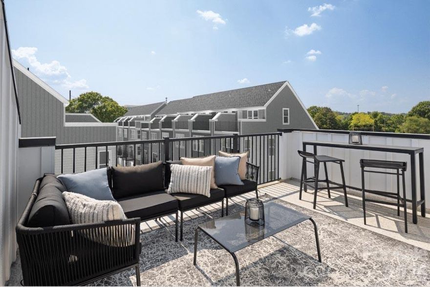 Located just minutes from Optimist Hall, less than a mile from the AvidXchange music factory, and only 2 miles from BOA Stadium. Iron Creek is a luxury townhome community with an exquisite selection of four-story townhome designs featuring rooftop terraces and 2-car garages. All appliances included. Closing costs paid and first year of HOA dues covered. This Dunhill floorplan showcases versatile living spaces designed with your city lifestyle in mind. The main living area is highlighted by a spacious great room, casual dining area, a well-crafted kitchen with access to the outdoor, rear deck, and a powder room for your guests. On the third level, the primary suite is enhanced by a large walk-in closet and a lavish private bath featuring dual vanities and a luxe shower with a bench seat. Adjacent, the guest bedroom features an en-suite bath and roomy closet. The fourth floor has another bedroom perfect for an office with great views from the stunning, rooftop terrace.