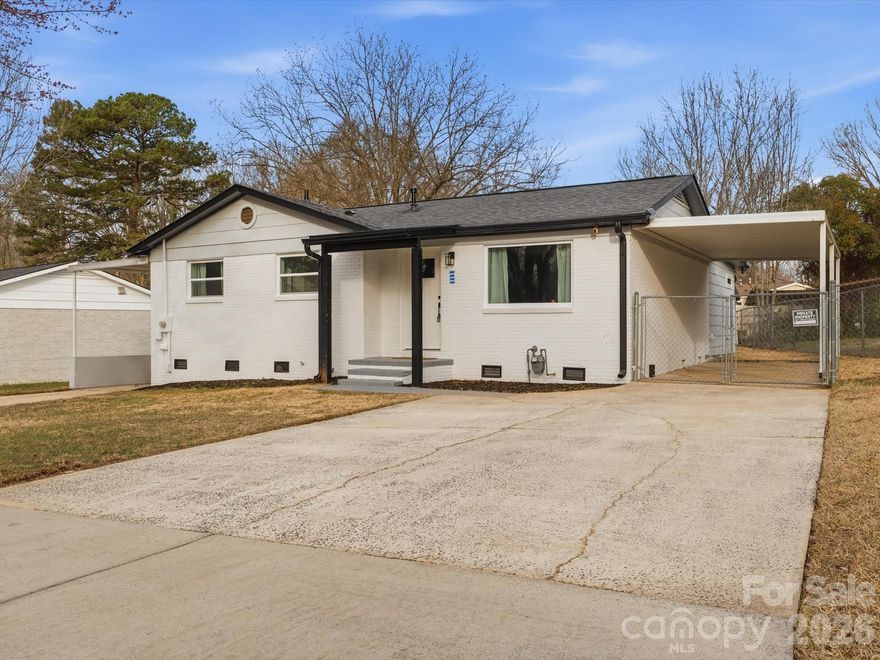 Beautifully updated and move-in ready, this home offers a functional open floor plan with modern touches throughout. The kitchen features new cabinets, complemented by updated bathrooms and new LED lighting across the home. The spacious primary bedroom includes its own fireplace and an oversized closet for ample storage. Enjoy outdoor living in the fenced backyard with a storage shed, plus the convenience of an oversized carport. Ideally located less than 2 miles to I-77, about 15 minutes to Uptown Charlotte, and 15 minutes to the university.