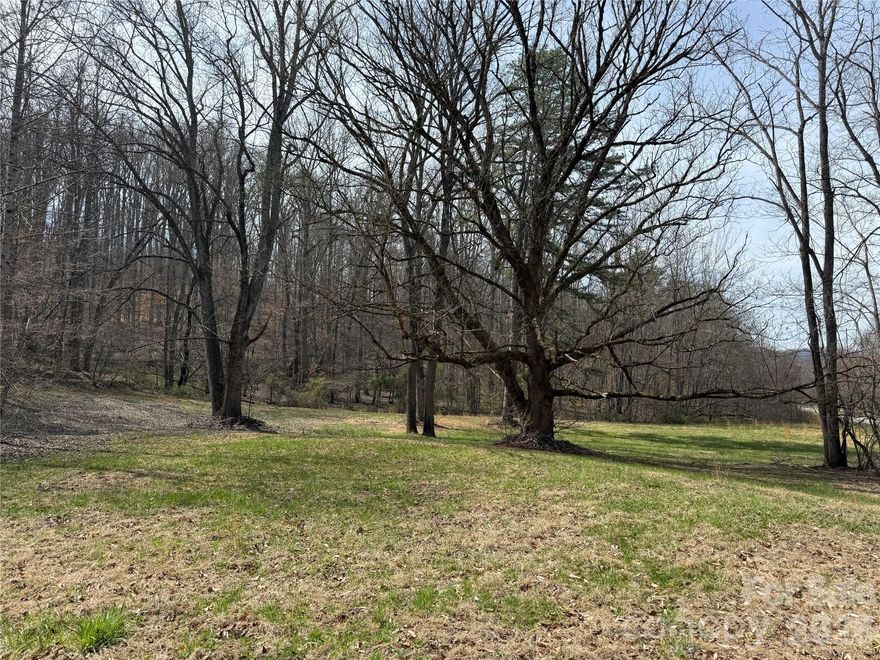 Looking to reimagine or build new? Unique opportunity in the heart of Barnardsville with exceptional potential. Nestled in a peaceful mountain setting, this 55+ acre property offers a beautiful natural backdrop with mature trees and the quiet charm of Western North Carolina. The land and setting are the true highlights, providing a serene environment with possibilities for a future mountain getaway, full-time residence, or investment project. Enjoy the privacy of a rural setting while still being within an easy drive of Asheville and surrounding amenities.

The one-level home will convey with existing contents remaining. Inside you’ll find a variety of household furnishings, books, an upright piano, vintage record player, bicycle, furniture, and more. All items convey with no assigned value, and buyer will be responsible for removal of any remaining personal property after closing. Seller will make no repairs. Gravesite on top of the property.