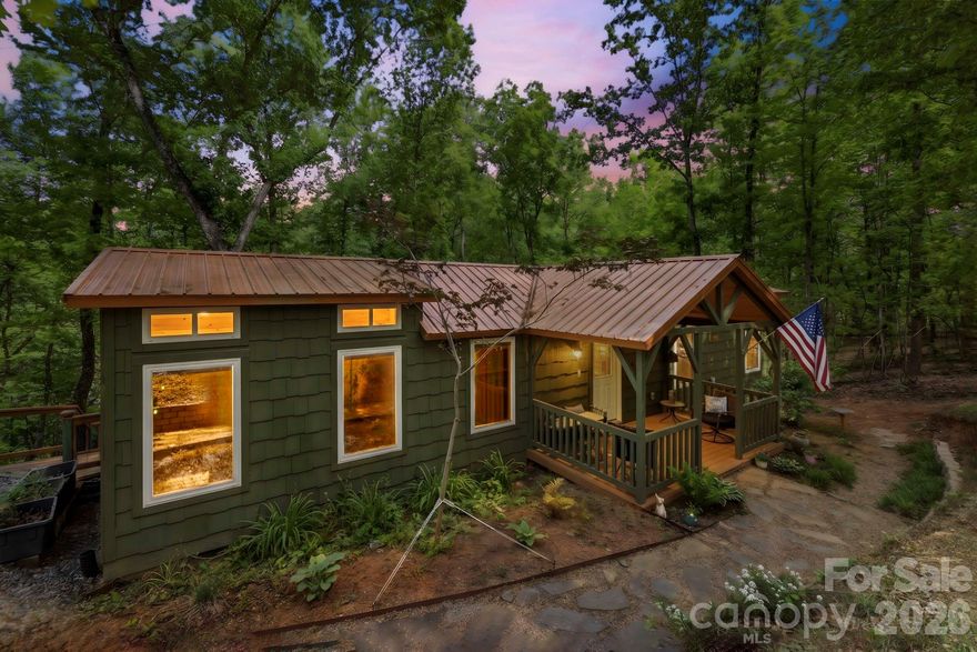 THIS CHARMING COTTAGE IS LISTED $25K BELOW RECENT APPRAISAL!!  It is designed for comfort and efficiency close to groceries, restaurants, Lake Lure and the Tryon Equestrian Center. The property features 2BR and a loft area creating an ideal retreat or investment opportunity. The level knoll adjacent to the garage presents excellent opportunity for constructing a primary residence, or add tiny homes for max income. Vehicle accommodation is generous, featuring 2-car detached garage, 1-car carport and ample parking.The outdoor living spaces are testament to relaxed country living. Welcoming covered front porch invites morning coffee moments, while screened-in back porch offers bug-free enjoyment of nature's symphony. The sunny back patio area, complete with a fire pit table, provides the perfect setting for evening gatherings under the stars. This move-in ready home comes completely furnished, allowing you to start living your dream lifestyle immediately. Find your investment property now before the crowds return as Lake Lure is opening up!  Recently inspected well, new well pressure tank w/iron and ph filter.  When you pull in and out of the drive, it feels like you are living in your own lush green world.  Come see!!