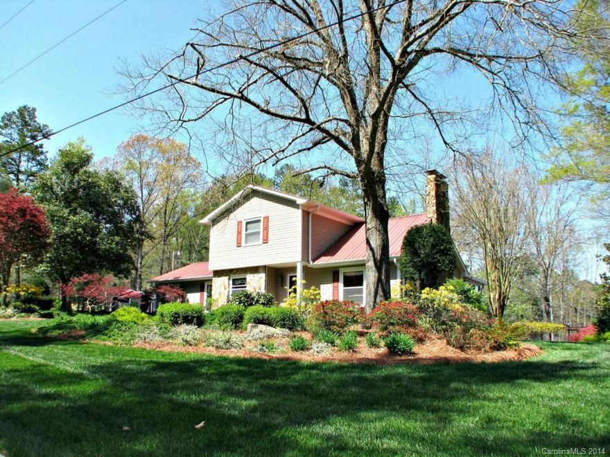 Secluded living at its best ! Lovely home with extensive landscaping. Enjoy the koi pond in back w/waterfalls from multi-level decks. Metal roof has lifetime guarantee. Appliances less than 2 years old. Beautiful wood floors and stone fireplace in greatroom. Sunroom overlooks  garden & koi pond. There are three storage sheds and a fenced pet shelter. The carport has power and lights.