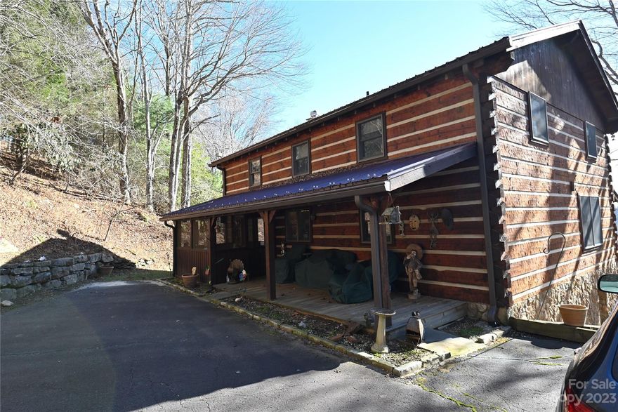 Beautiful, cozy hand-crafted log home (Bill Hinkle – Builder) located on 5 acres with approximately 300 feet of New River frontage. This one-of-a-kind home is conveniently located in the gated development of River Ridge near Boone, NC. This 2,688 SF home features a floor to ceiling stone fireplace, an open kitchen, dining and family room with direct access to the spacious deck with breathtaking views! The main level bedroom provides the same access to the deck and a large bathroom featuring a large jetted-tub, tiled shower, granite countertops and copper sink. The upper level features 3 bedrooms a full bath and an office. The lower level includes a spacious family room (or sleeping area), a custom bathroom and a spacious laundry room. Outside you will find ample parking, a 216 SF stone storage building and a 320 SF composite observation deck where you can sit around the fire pit and gaze at the mountain views, the New River and the abundant wildlife. A very special and unique property!