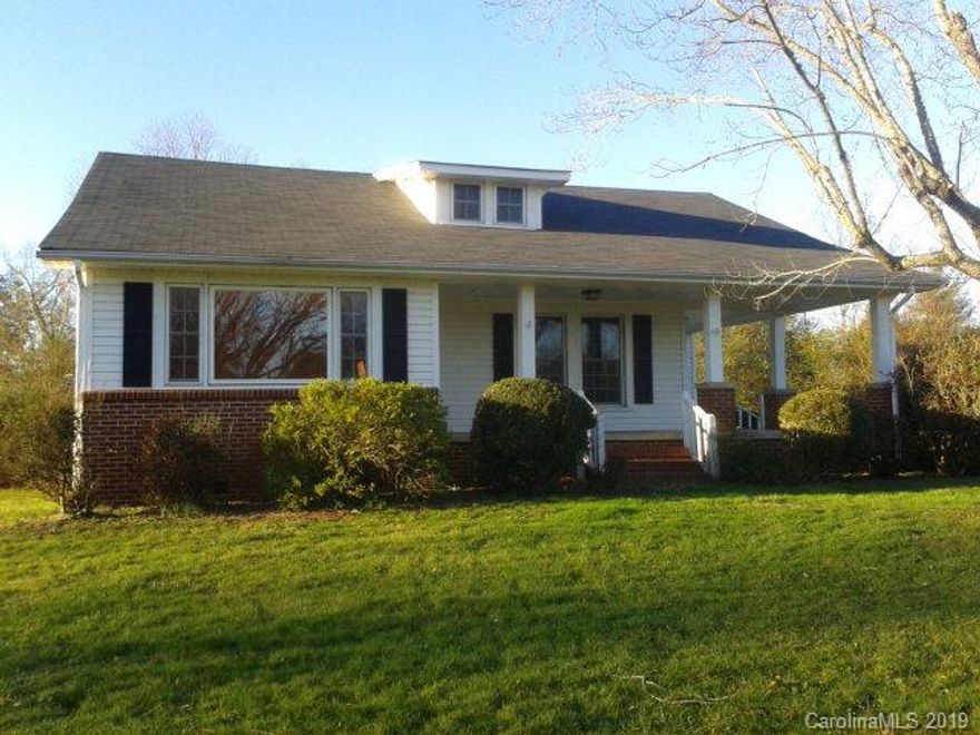 Farmhouse style home has great rocking chair ready covered front & side porches. Home has a living room w/FP and den w/picture window.The kitchen is roomy with appliances included, as as a butcher block island and microwave cabinet. The dining room adjoins the kitchen and has a double window.There is one bedroom and bath on the main level. Also, a large laundry/mudroom. Upstairs there are 2 additional bedrooms and a den area with large closet, however, these rooms do not have a permanent source of heating and cooling. Other features include: replacement windows, wood flooring, propane gas furnace, sump pump in cellar, large level fenced backyard, 2 car carport. Located close to Lake James!