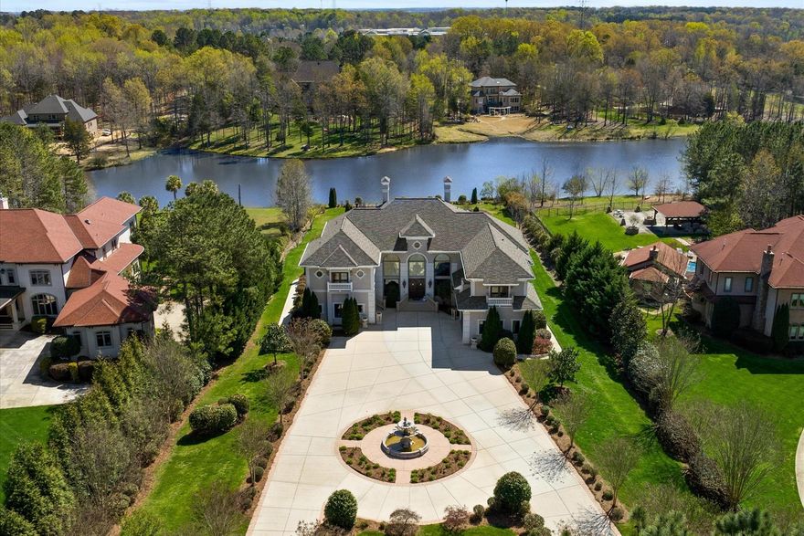 Back on Market due to no fault of seller.  Stunning waterfront view & a magnificent dual staircase greet you upon entering this gorgeous estate basement home in a gated community.  The 2-story great room has large windows to take in water views & tiered gardens.  The great room has electric fireplace & bar area. An Elevator goes to all three floors.  Desirable guest room on main floor. Newly refinished hardwood floors. A large terrace is the perfect place to enjoy the gorgeous views and sunsets. The primary guest suite has fireplace, sitting room, incredible views and large ensuite with tub and walk-in shower plus dual walk-in closets.  One bedroom could be used as an office, large bed/bonus has fireplace. Laundry up.  Basement features high ceilings, a rec room, wet bar, second kitchen, bedroom with ensuite, theater room & flex space. Large covered porch area. Plenty of storage. Award winning schools, low Union Co. Taxes. Community pond stocked with fish.