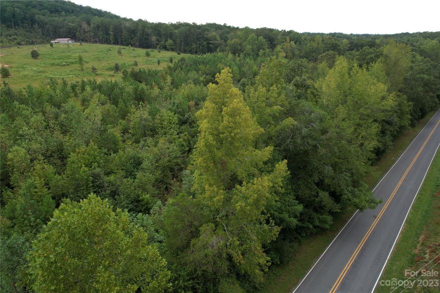 Beautiful, private, 5+/- acres adjacent to approximately 2000+ acres of Uwharrie National Forest Service Land.   Build your secluded retreat on this parcel and roam acres and acres of US Forest land, right outside your door. Horseback riders and hikers - this could be your paradise!   This parcel is approximately 5 acres with 1000 feet of road frontage.  Land is scheduled to be surveyed.  Please see the pictures in the photo section with the approximate measurements. Well and septic will be needed. Zones Res-3: Manufactured or stick built homes allowed.