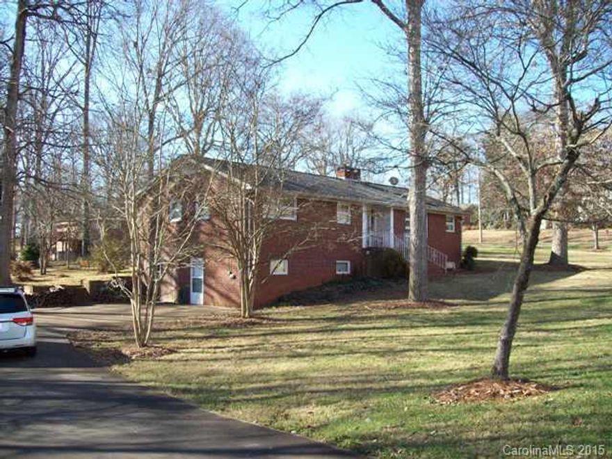 All brick ranch with a full unfinished basement. Corner lot almost 1 AC. Many flowering trees & shrubs. 2 driveways/each level w/an entrance & parking for 6 cars off street. Two full baths. FRM w/gas logs, Kit. w/ almost new DW & Fridge. Unf bsmt w/2 rooms, half bath, Fridge & range, wood burn fp. 11'x17' rear deck w/handicap ramp. Elect. handicap stairway chair remains. Furnishings negotiable. (Seller ready to move to Florida--bring an offer! Priced under tax value.)