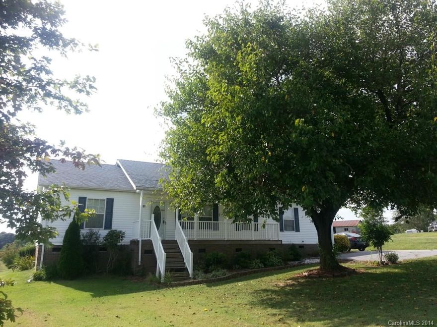 The idyllic country setting of this home makes life a little more peaceful.Mature landscaping.Backyard features three separate fenced areas and four outbuildings. Unique floor plan offers two spacious living areas, one with a wood-burning fireplace.Another unique feature is a back entrance leading into the untility/laundry room that joins a Jack and Jill bath that also joins the hallway.Kitchen has a space to add a dishwasher.Close to 3 great schools.Close to Lake Norman. Well under tax value!