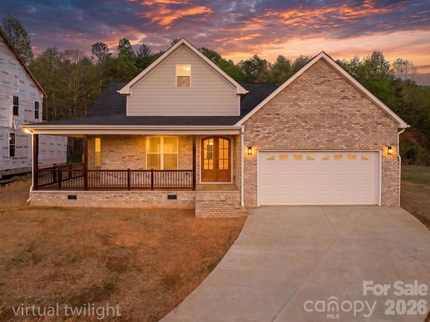 Stunning new construction offering over 2,200 square feet with thoughtful design and quality finishes throughout. The double arched door entry creates a striking first impression, leading into an interior defined by tall ceilings and an open, airy layout. This 3 bedroom, 2.5 bath home blends modern functionality with timeless design for one level living. 

The kitchen serves as the centerpiece of the home, featuring a large island, custom all-wood cabinetry, and ample space for both daily living and entertaining. The primary suite is well-appointed with a spacious tiled walk-in shower, walk in closet, double vanity, and private water closet.

Covered front and rear porches provide comfortable outdoor living, with a front porch view of Grandfather Mountain that adds a rare and desirable backdrop. Located in desirable Huntington Woods development in Lenoir, close to HWY 321, just 30 minutes from Blowing Rock and 30 minutes from Hickory.