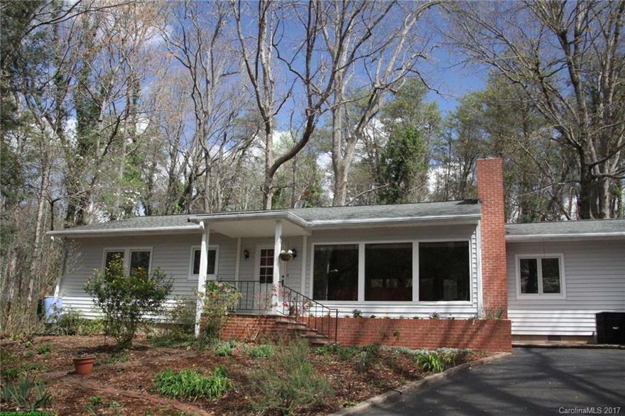 Your cabin-in-the-woods home. On 1.08 acres in the quiet, pristine Warrior Road neighborhood. Views of the woods, wildlife and country lanes looking out a gallery of picture windows. All this just minutes from Harmon Field park, Tryon and Columbus restaurants, arts & crafts and grocers. Comfortably finished, pine walls everywhere; hardwood floors in the living, dining and bedrooms. Cork floors and concrete counters in the updated kitchen. Energy Star appliances. The best of all worlds.