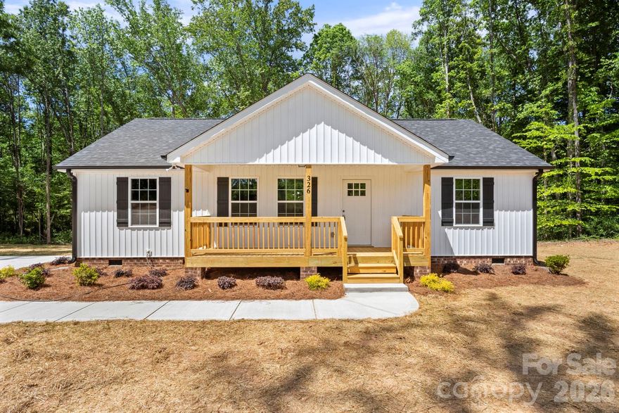 Tucked away at the end of a long gravel drive, this home is perfectly positioned within a serene, wooded setting. The private backyard offers a peaceful retreat rarely found in today’s market!! Ideally located just minutes from the charming yet vibrant downtown York, South Carolina, offering convenient access to local shops and restaurants.

Enjoy the charm of upgraded craftsman-style trim throughout this adorable 3 bed/2 bath ranch, paired with the ease of low-maintenance new construction. Right inside the front door, the open-concept main living area is highlighted by a tall, vaulted ceiling. The kitchen features a large island with overhang for barstool seating, granite countertops, and crisp white shaker-style cabinetry. The primary suite has a massive walk-in closet and a well-appointed primary bath featuring a double vanity and granite countertops. No more tiny laundry closets — This home features a large, dedicated laundry room with the space and functionality today’s buyers are looking for. Covered front and back porches create ideal spaces for relaxing or entertaining.