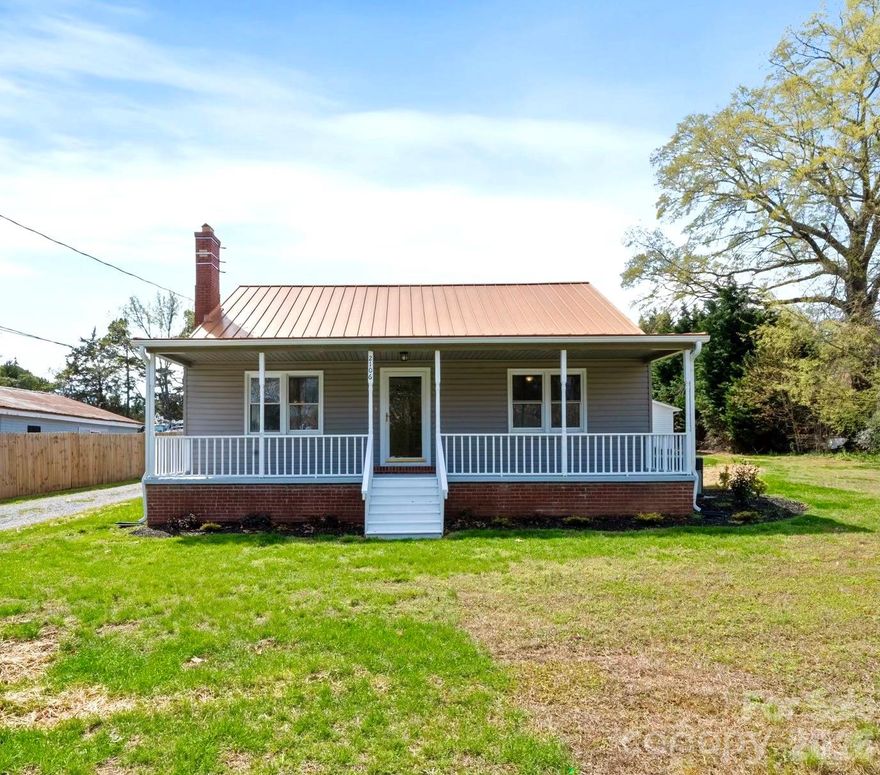 Fully renovated 2BR home with an oversized workshop on a high-visibility Statesville Hwy parcel — an ideal live/work opportunity, office conversion, investment property, or redevelopment site. Situated on approximately .52 acres, this rare property offers exceptional flexibility in a prime Mooresville location. Features include a beautifully updated kitchen with white cabinetry, butcher block countertops, stainless steel appliances, new flooring throughout, fresh interior and exterior paint, and a new roof. The spacious open layout is filled with abundant natural light and includes a charming fireplace. The detached 1,440 SF workshop/garage is a standout feature, complete with epoxy-style floors, bright overhead lighting, and an oversized garage door, making it ideal for business use, storage, hobbies, automotive work, or a true live/work setup. With excellent road frontage, strong visibility, and versatile CM zoning, this is a rare opportunity to own a beautifully renovated property that offers both residential comfort and commercial potential in the heart of Mooresville. Buyer to verify intended use.