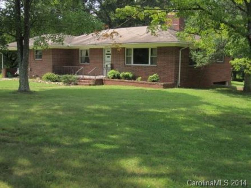 Mini farm with brick ranch/basement on just over 4 acres of land boasts a brand new architectural shingle roof just installed.  The kitchen has lots of cabinets and built-ins, masonry fireplace in living room.  Wood floors under all carpet per owner.  The house is heated with hot water heating, plus fencing and a barn on property too which is in fair shape.  Nice patio area.  Very pretty land.  Basement unfinished but has fireplace, sink, and old shower, +1 car gar