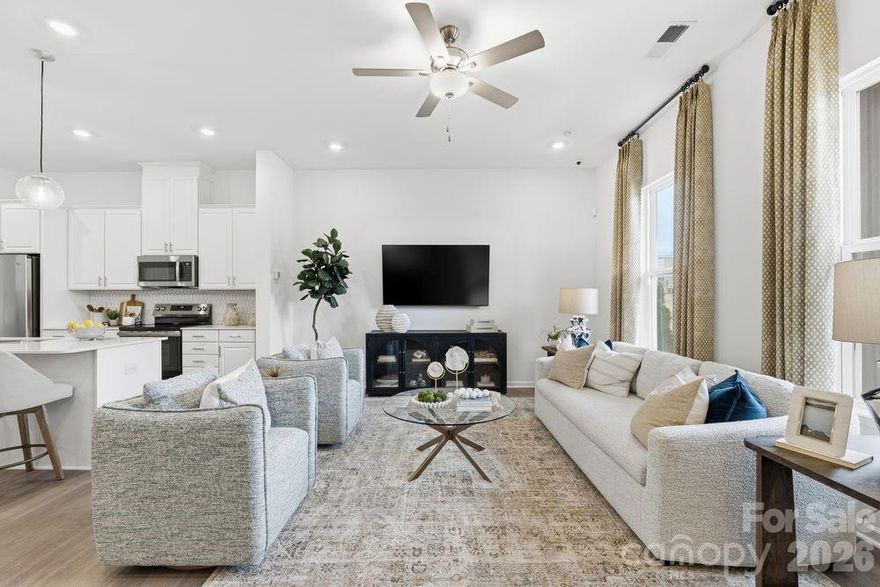 What's Special: Best Seller | Loft | Backs to Open Space | Oversized Garage. New Construction - April Completion! Built by America's Most Trusted Home Builder. Welcome to the Aspen at 5553 Wolfpack Alley in Terraces at the Exchange! This charming new townhome features an open-concept living area where the great room flows effortlessly into the dining area and the kitchen with a center island and walk-in pantry. A convenient powder room sits near the rear garage entry. Upstairs, an inviting layout offers a loft and tech space at the top of the stairs. Two secondary bedrooms with walk-in closets share a full bathroom, while the private primary suite includes an en-suite bath and two walk-in closets. The laundry room is also upstairs for added convenience. Residents will love walking to the Exchange, a new retail hub featuring Costco, Lowe’s Foods, Club Pilates, and more. With easy access to Hwy 521, I-485, I-77, and I-85, the area is growing fast. Nearby Swig and CrossRidge offer Target and a YMCA, while the Promenade at Carolina Reserve adds T.J. Maxx, HomeGoods, Starbucks, and more. Plus, Charlotte Douglas Airport is just 30 miles away. Additional Highlights Include: LVP flooring throughout main level. Photos are for representative purposes only.  MLS#4359830