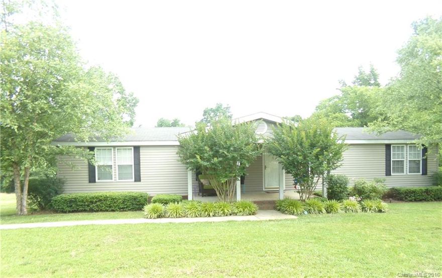 Don't miss this spacious and inviting manufactured house located on almost 2.5 acres!  It features a split floor plan, which affords plenty of privacy to the large master bedroom and bathroom with soaking tub and shower.  The kitchen, which is adjacent to the dining and den with FP, is a great entertaining space that leads to the rear deck with above ground pool/play set, as well as the two bedrooms and full hall bathroom. The paved driveway and sidewalks, lead to the shady front covered porch.