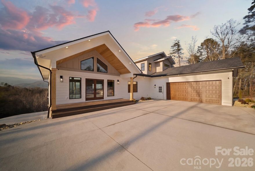Experience the pinnacle of luxury mountain living in this brand-new 4-bedroom, 4.5-bath custom home, thoughtfully designed and impeccably built on 4 private acres in the heart of Western North Carolina. Perfectly positioned to capture long-range, unobstructed mountain views of Mount Mitchell and the Black Mountains, this home offers a rare blend of modern sophistication, structural excellence, and timeless natural beauty just minutes from downtown Old Fort.

From the moment you arrive, the quality of construction is evident. The home is anchored by a poured concrete block foundation, providing superior durability and peace of mind, and finished with low-maintenance Hardie® board siding, ideal for mountain conditions. A two-car main-level garage offers everyday convenience, while a separate one-car lower-level garage provides additional storage or flexibility for outdoor gear, workshop space, or owner use—an ideal feature for a short-term rental setup.

Inside, refined design meets intelligent living. A beautifully lighted stairway creates both ambiance and safety, while expansive windows flood the home with natural light and frame breathtaking mountain vistas from multiple levels. The chef’s kitchen with instant hot water pot filler is a true centerpiece, featuring undercabinet lighting, integrated under-cabinet electrical outlets, and swing-out appliance shelving that keeps countertops clean and functional—perfect for entertaining or accommodating guests. Subtle Eve lighting throughout the home enhances mood and efficiency, while installed security cameras add a layer of smart-home convenience and peace of mind.

Each of the four bedrooms is generously sized and thoughtfully laid out, with spa-inspired en-suite bathrooms that deliver comfort and privacy. The additional half bath adds functionality for gatherings and guest use. Whether hosting friends, family, or visitors, the layout flows effortlessly while maintaining private retreats throughout the home.

This property is exceptionally well-suited as a high-performing Airbnb or luxury short-term rental. The combination of dramatic views, modern amenities, multiple garage spaces, and proximity to outdoor attractions makes it highly desirable for travelers seeking an upscale mountain escape.

Located just minutes from the vibrant charm of Old Fort, owners and guests alike will enjoy quick access to some of Western North Carolina’s most sought-after attractions, including Pisgah National Forest, Catawba Falls, the Fonta Flora Trail, world-class hiking and mountain biking, trout fishing, and scenic drives along the Blue Ridge foothills. Old Fort’s revitalized downtown offers local breweries, restaurants, art, and community events, while Asheville is a short 25 minute drive away for dining, shopping, and entertainment.

Whether envisioned as a luxury primary residence, mountain retreat, or income-producing vacation rental, this exceptional new-construction home delivers iconic views, modern comfort, and long-term value—a rare opportunity to own a standout property in one of North Carolina’s fastest-growing mountain destinations.